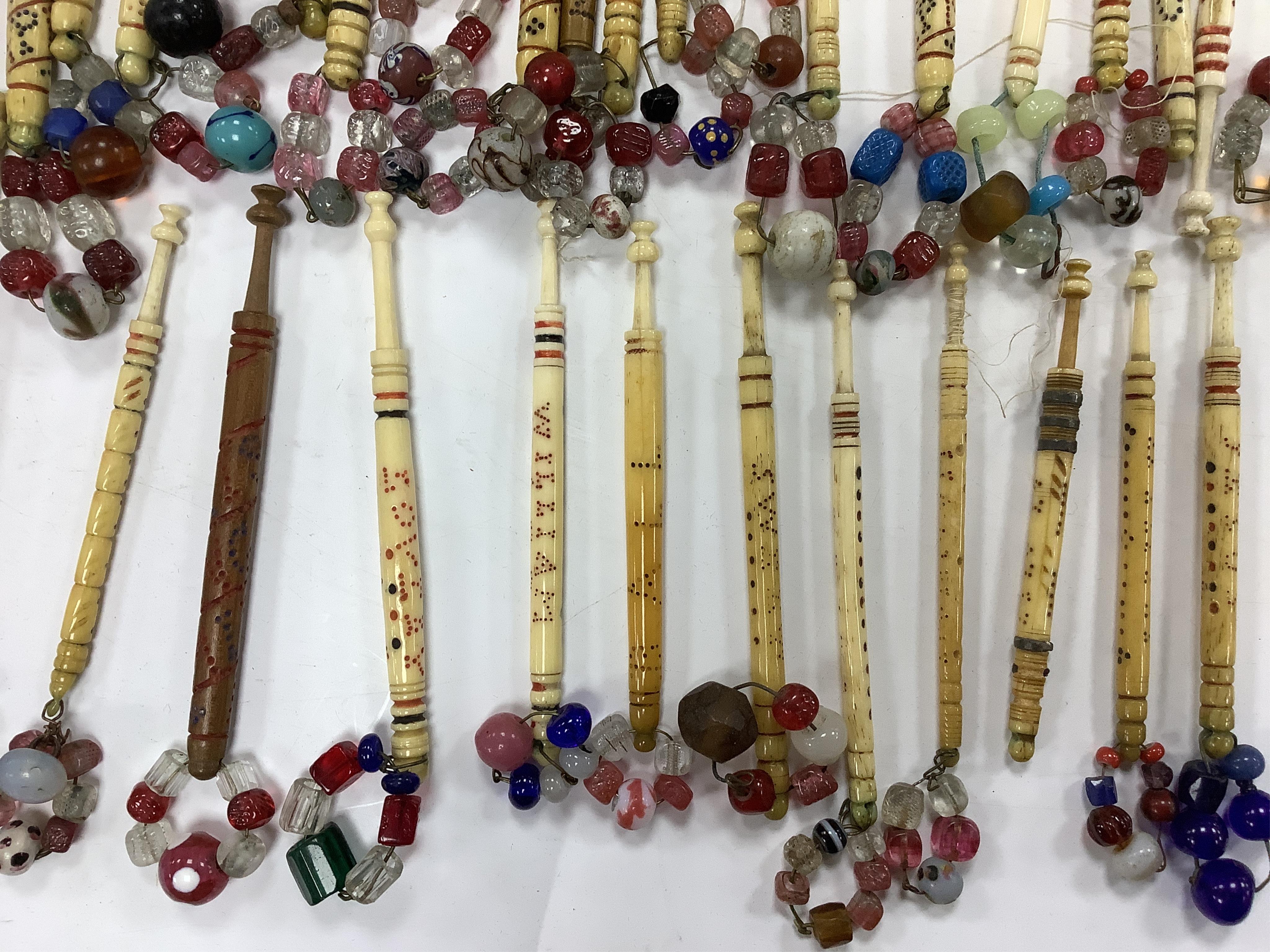 A collection of 19th century named and motto bone lace bobbins, including three named Barry bobbins with a related EB red embroidered monogram to lace edged hankie.(31 bobbins) Condition- light rust staining to hankie, b